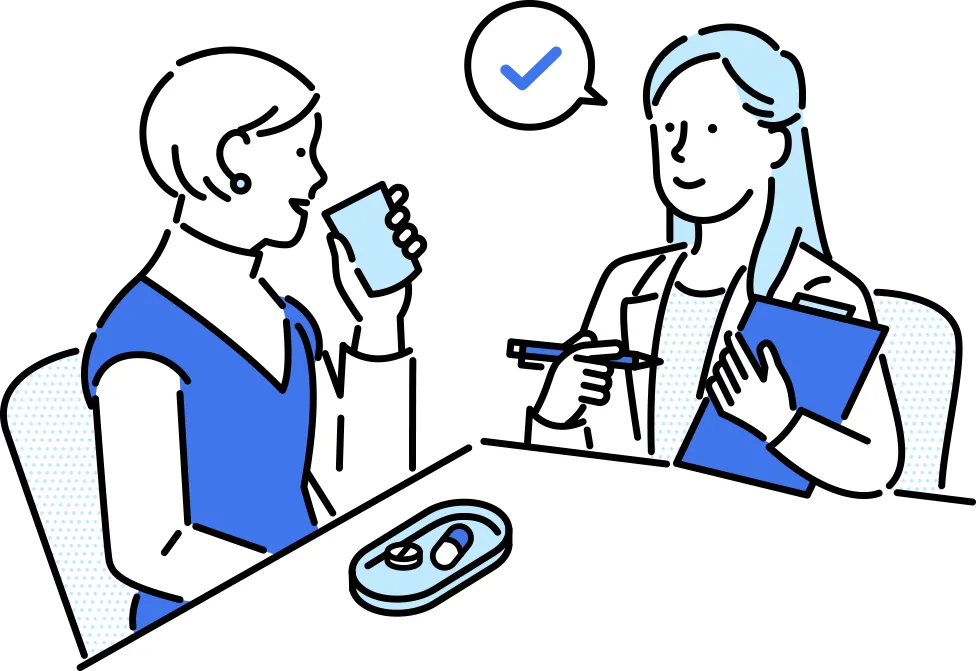 医師の指導の下、薬を服用する女性の画像